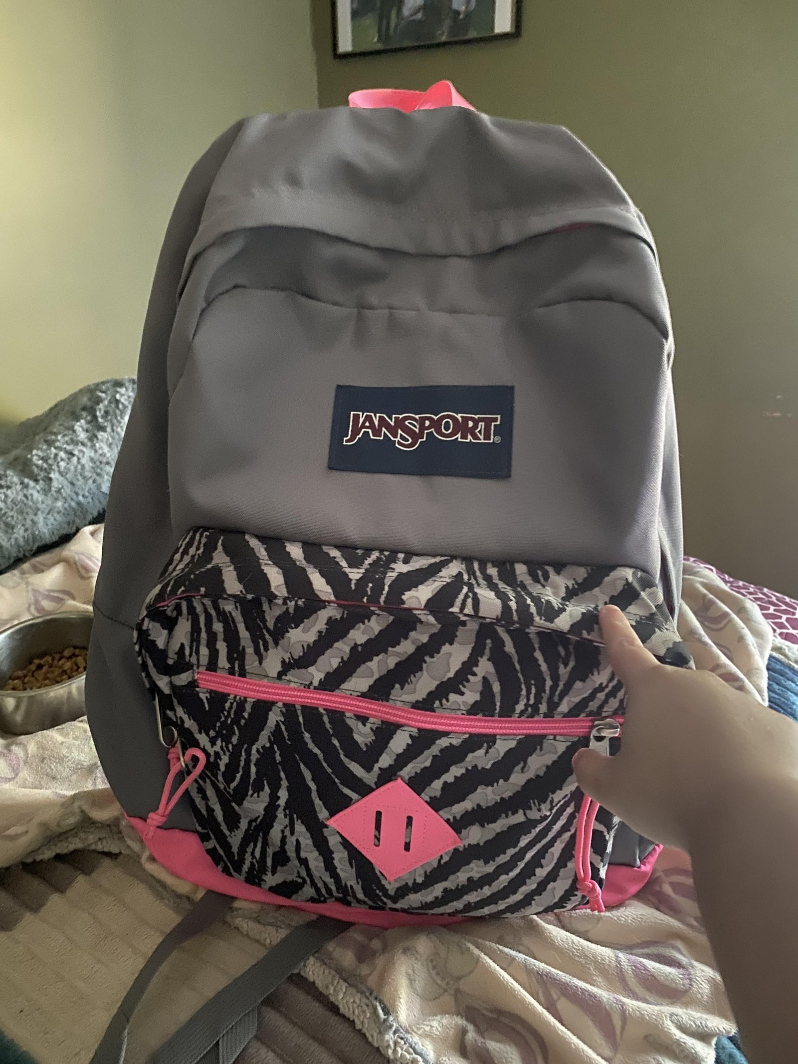 A traveler checks airline carry on size limits before packing their Jansport backpack.