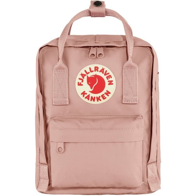 Inspecting a mini backpack during a price comparison research session on a laptop.