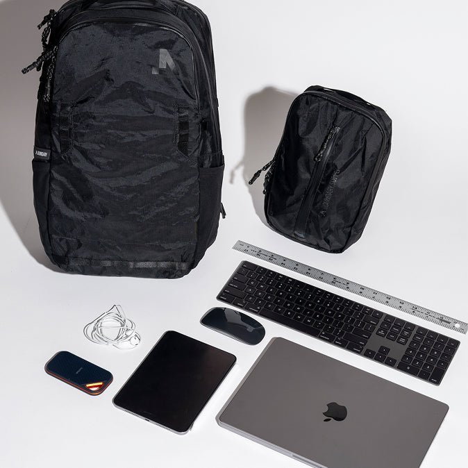 A person in a store adjusts a travel backpack to ensure a comfortable fit.