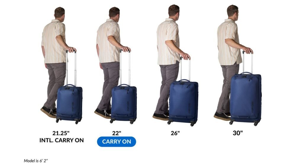 A modern 22-inch carry-on suitcase standing in a bright airport terminal.