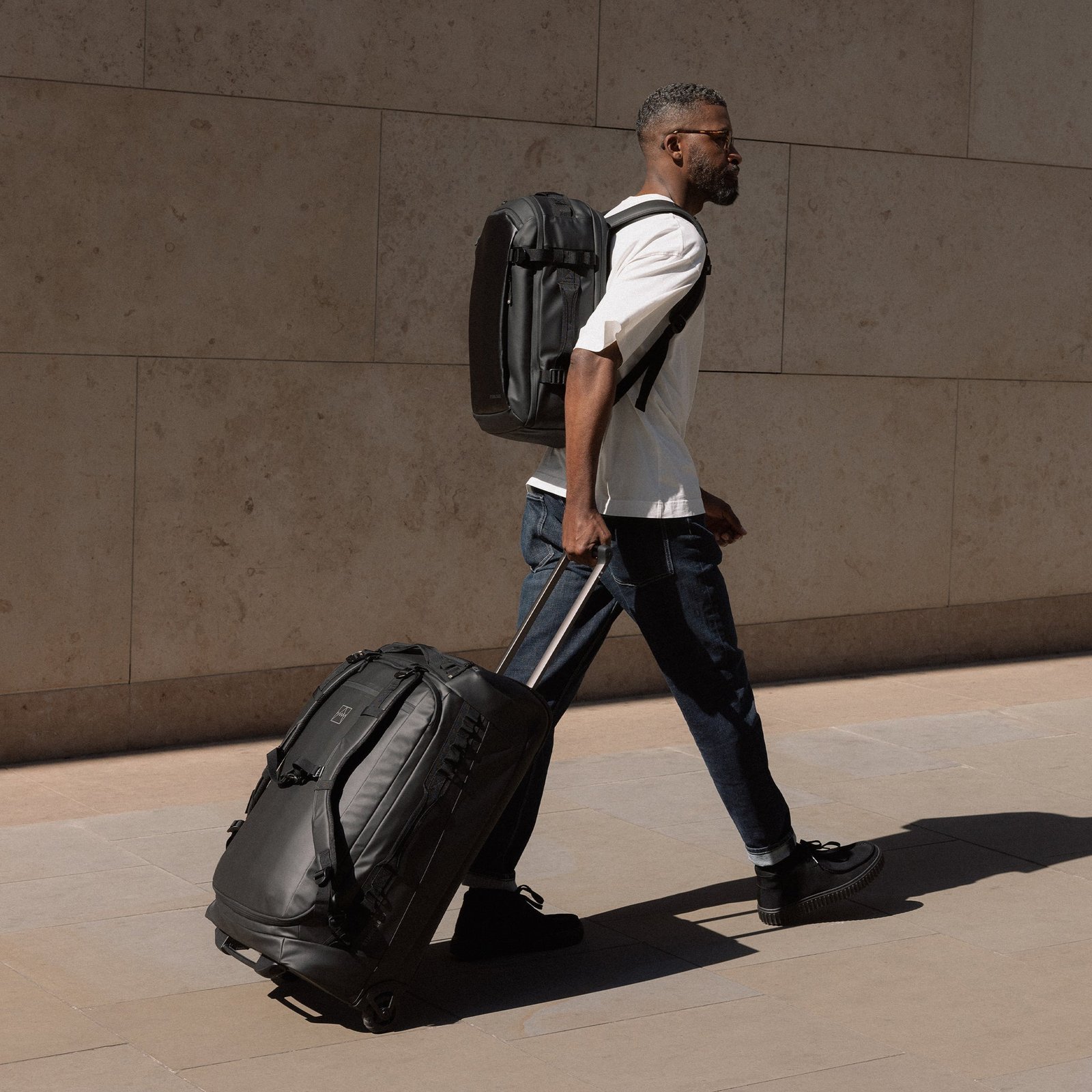 Travel accessories and a lifestyle backpack arranged neatly for a trip.