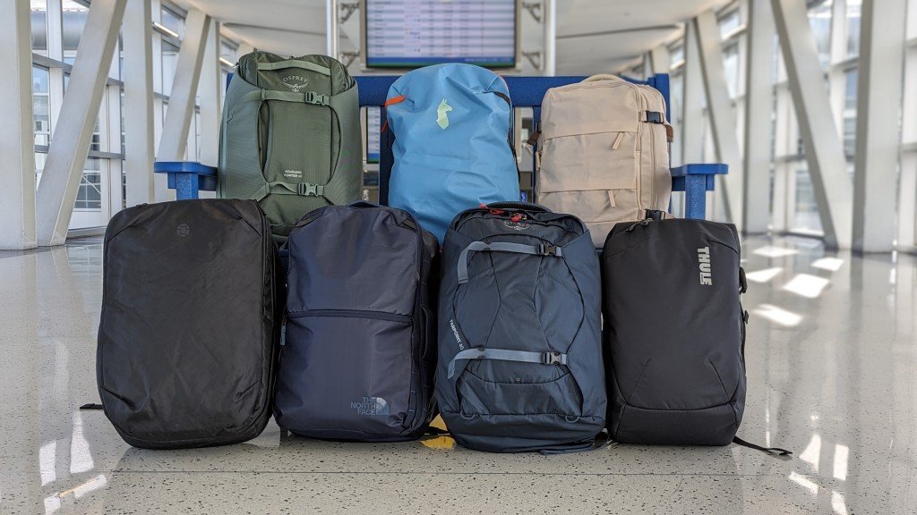 A sleek lightweight travel backpack stands ready for a journey in an airport terminal.