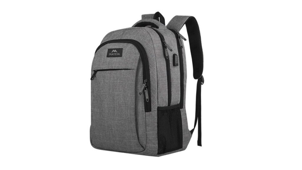 A middle school boy walking through a hallway carrying a high quality school backpack.