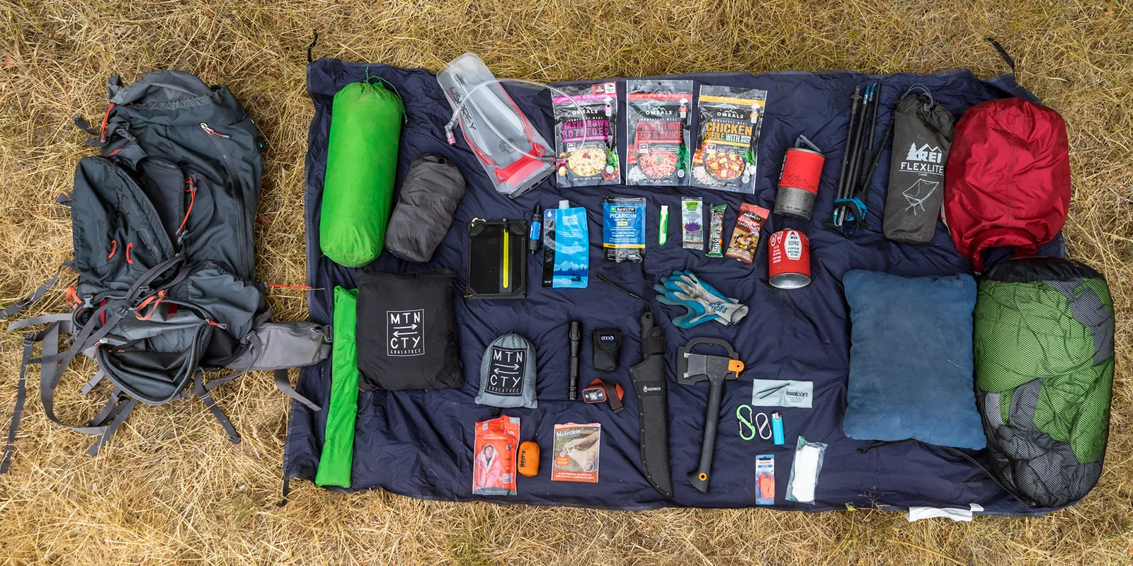 A person removing an internal frame sheet from a modern backpacking pack.