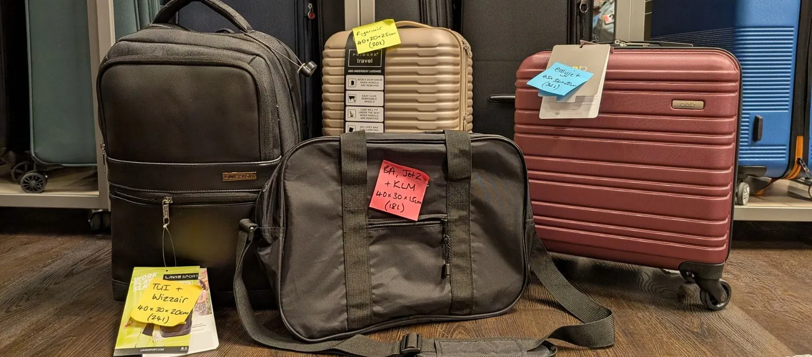A small carry-on suitcase and a backpack shown together on a clean floor.
