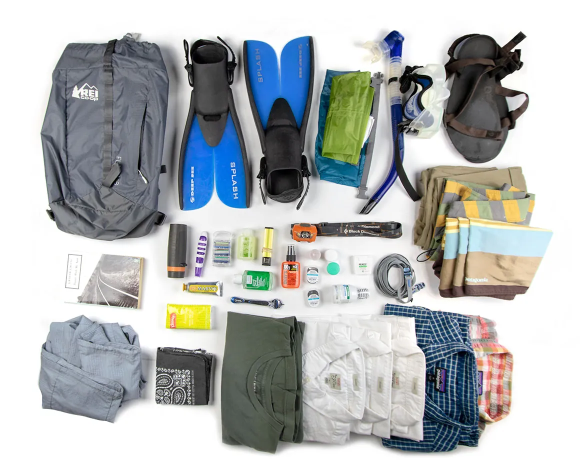 A traveler waits in an airport lounge with their backpack and carry-on suitcase.