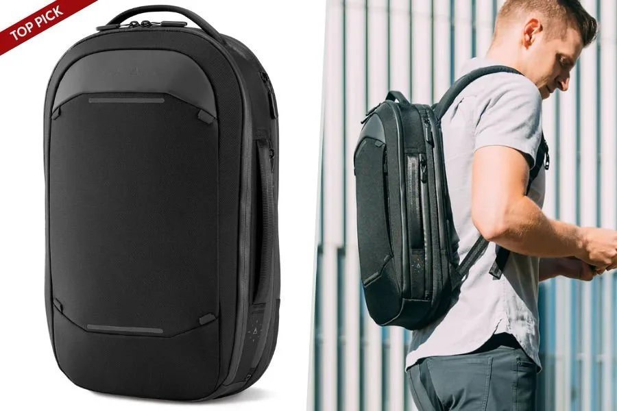 A small travel backpack sits upright with travel accessories on a wooden floor.
