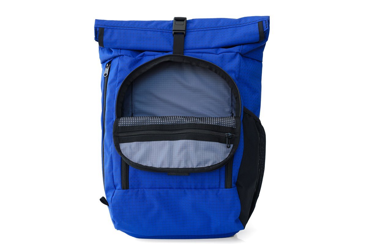 A large internal frame trekking backpack displayed on a wooden floor.