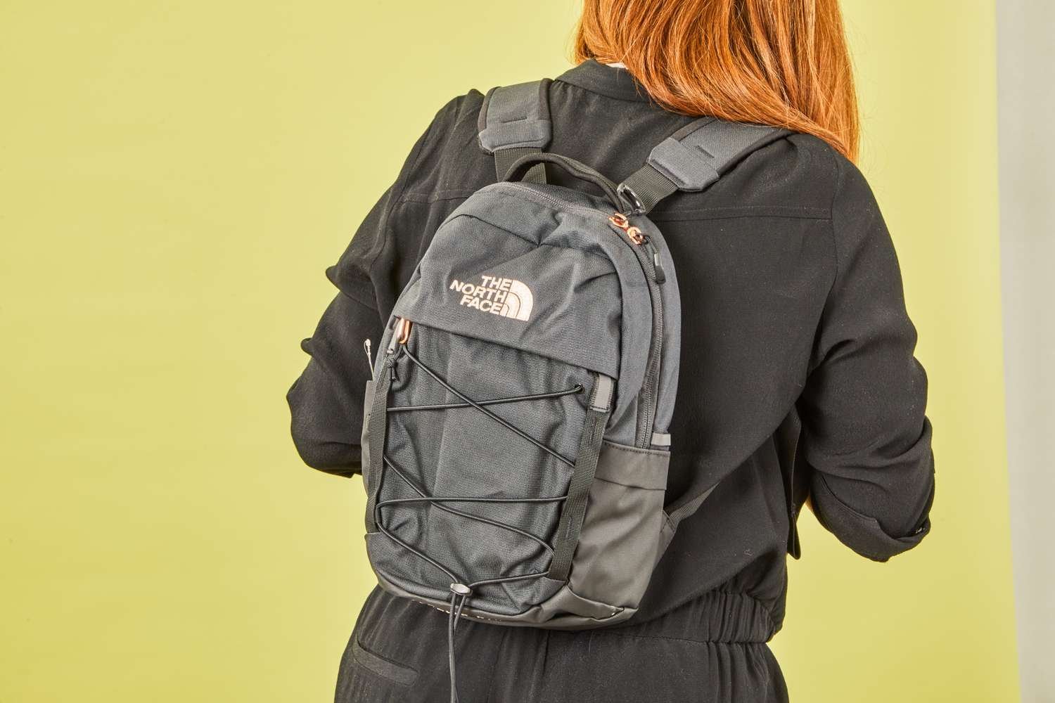 A slim commuter backpack designed for laptops sits on a modern office desk.