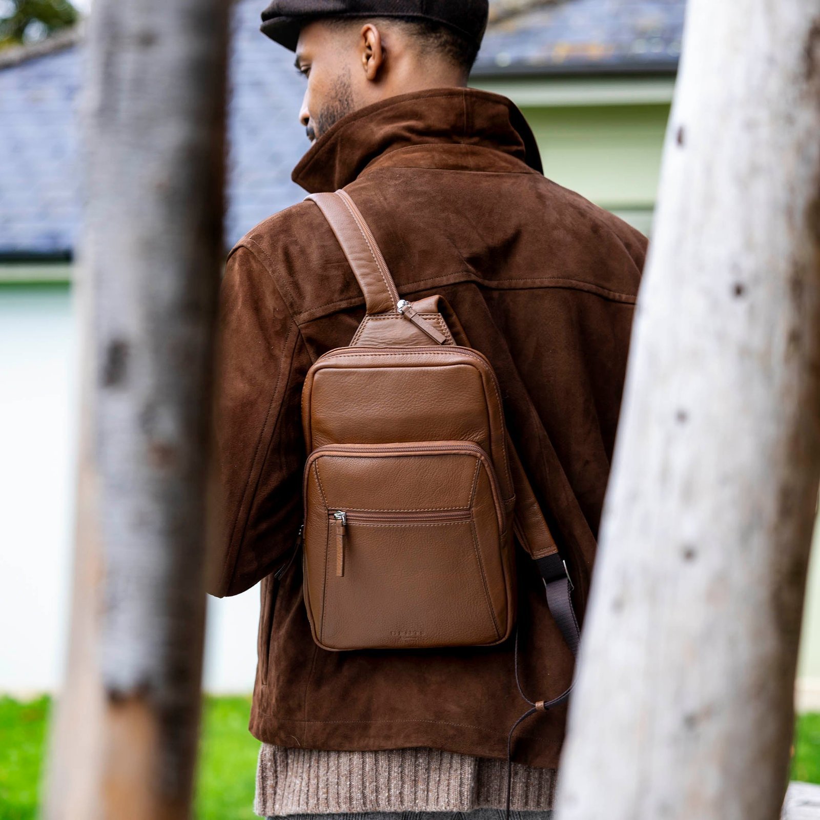 A close-up view of reinforced stitching and smooth zippers on a mini backpack.