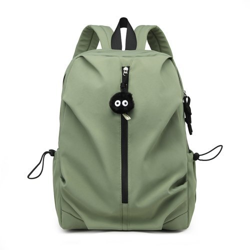 A person tests the comfort of a small backpack in an outdoor store.