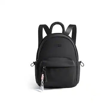 Two different styles of small backpacks are displayed side by side on a table.