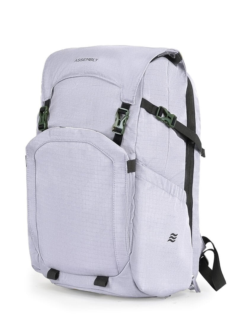 Browsing a variety of high-quality backpacks on a laptop screen in a bright office.