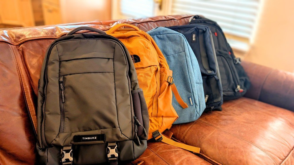 A customer adjusting a technical backpack inside an outdoor specialty retailer.