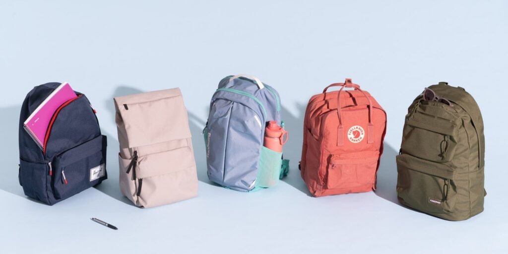 A variety of high-quality backpacks arranged in a modern retail display.