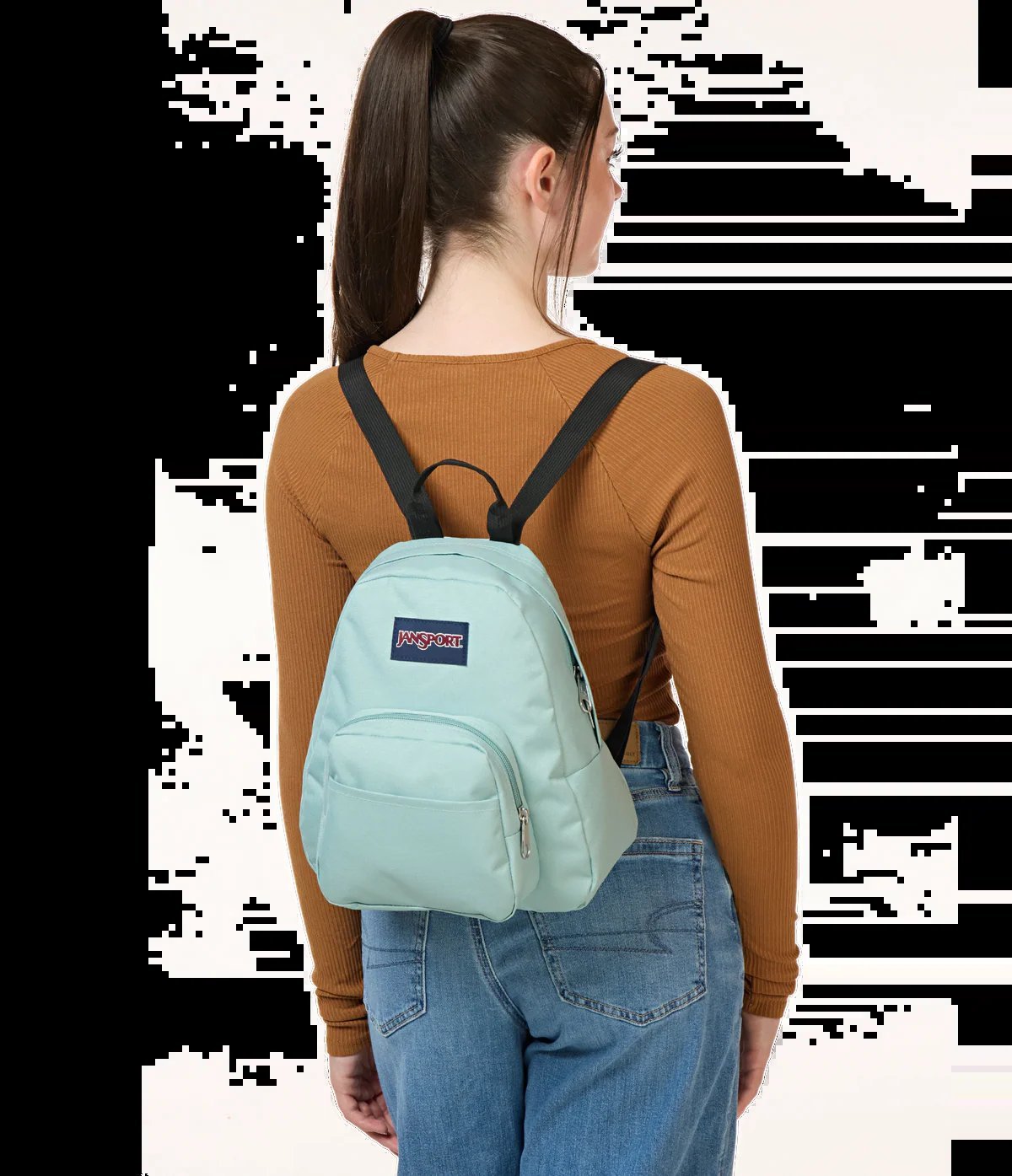 A mini backpack resting on a desk next to a laptop and notebook.