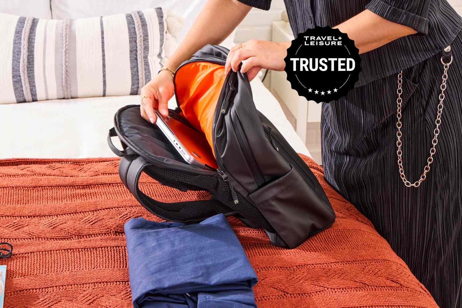 A laptop sliding into a perfectly sized padded sleeve inside a backpack.