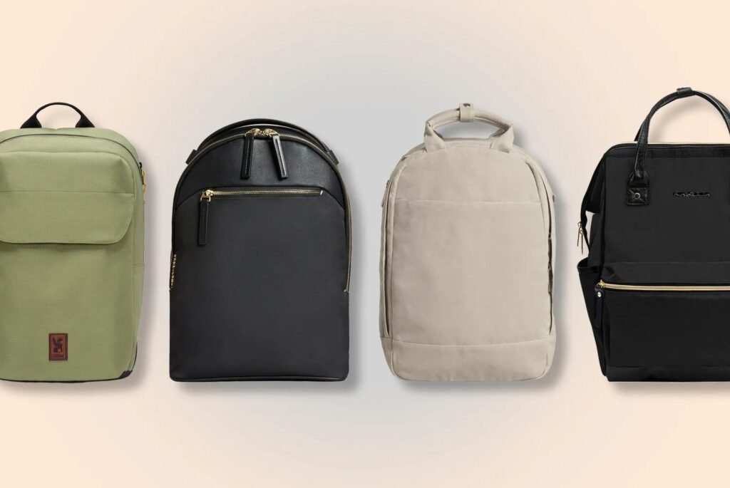 Charcoal women's laptop backpack on white desk in sunlit home office
