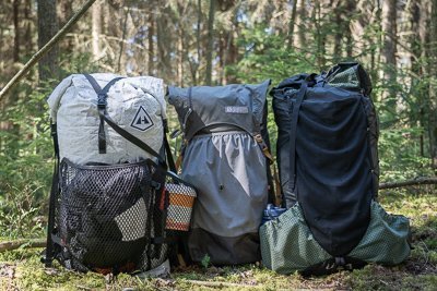 A durable hiking backpack sits on a mountain ridge during a long-distance hike.