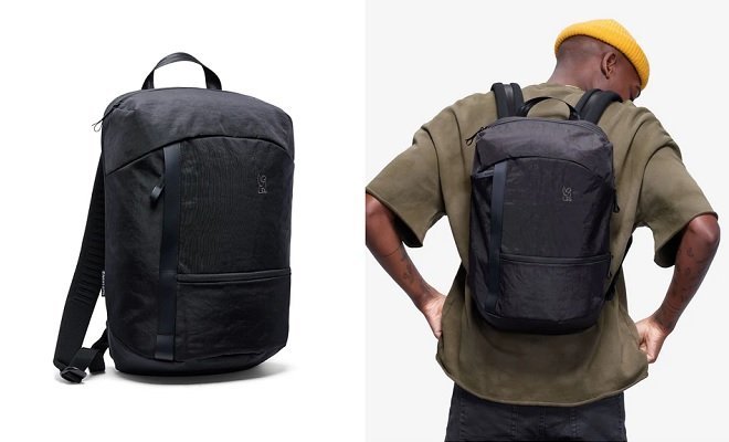 A sleek everyday carry backpack sits on a polished concrete office floor.