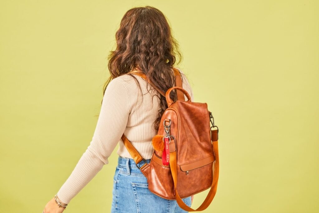 A stylish leather purse backpack sits on a cafe table for travel photography.